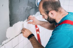 Beaverton Tile worker installing tiles on the wall