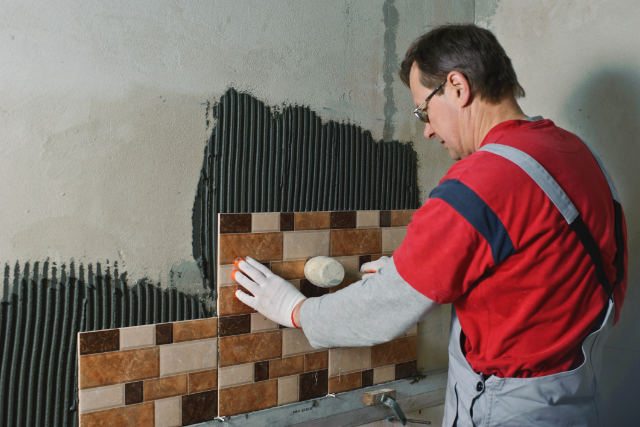 Beaverton worker laying ceramic tiles